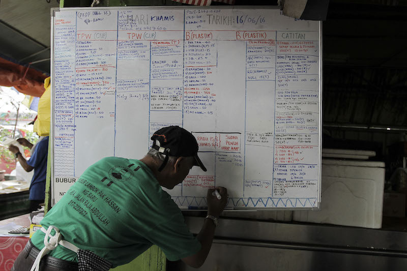 Pak Hassan has a list of blue chip customers ranging from banks to major corporations, and here is the white board where orders are registered.