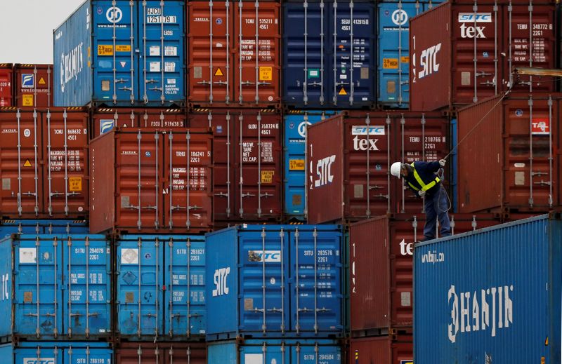 A labourer works in a container area at a port in Tokyo, Japan, March 16, 2016. u00e2u20acu201d Reuters pic