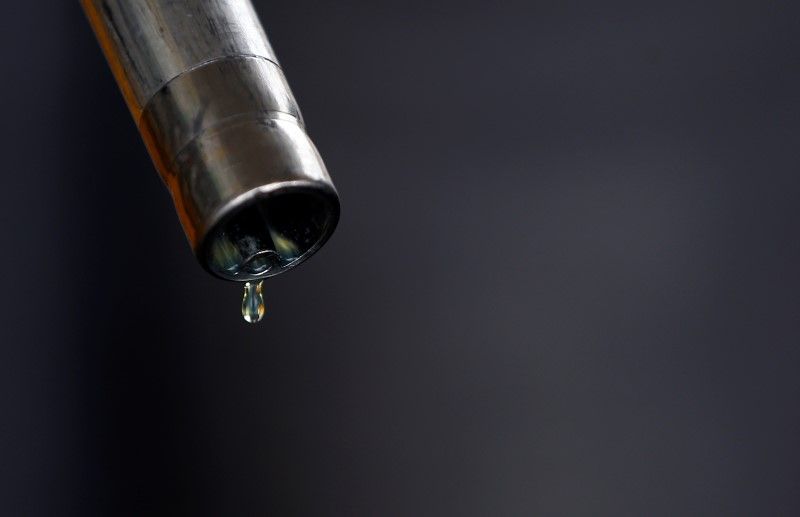 A drop of diesel is seen at the tip of a nozzle after a fuel station customer fills her car's tank in Sint Pieters Leeuw December 5, 2014. u00e2u20acu201d Reuters pic