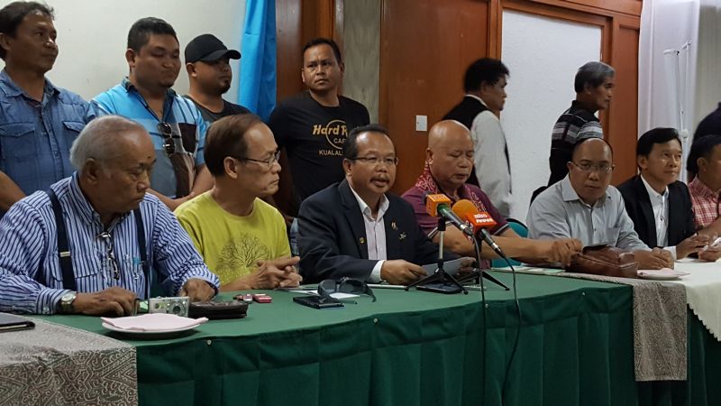 Sarawak Dayak Graduates Association (SDGA) president Dr Dusit Jaul (seated, centre) reading out a joint statement by 13 Dayak NGOs at a press conference. June 21, 2016. u00e2u20acu2022 Picture by Sulok Tawie 