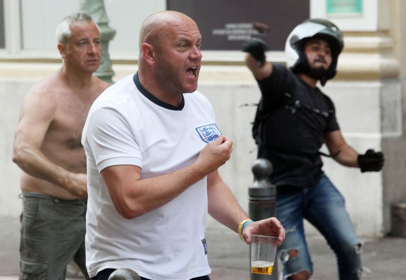 A supporter shows his shirt in street brawls ahead of the Euro 2016 football match England vs Russia, historic Vieux-Port district, Marseilles, June 11, 2016, third day of pitched battles JEAN CHRISTOPHE MAGNENET / AFP