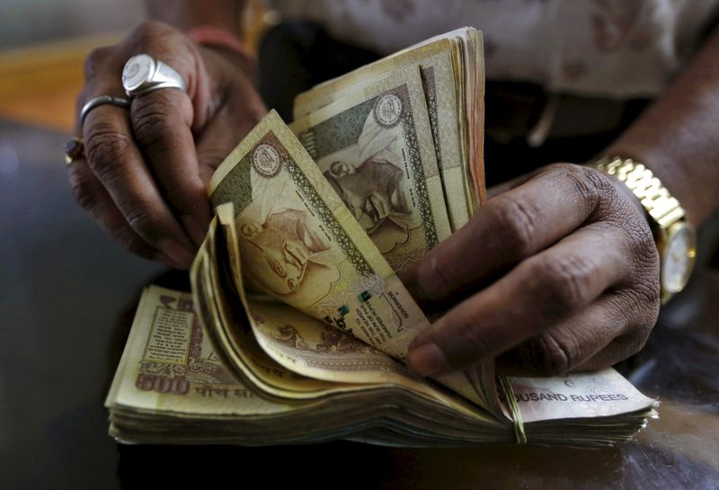 A money lender counts Indian rupee currency notes at his shop in Ahmedabad, India May 6, 2015. u00e2u20acu201d Reuters pic