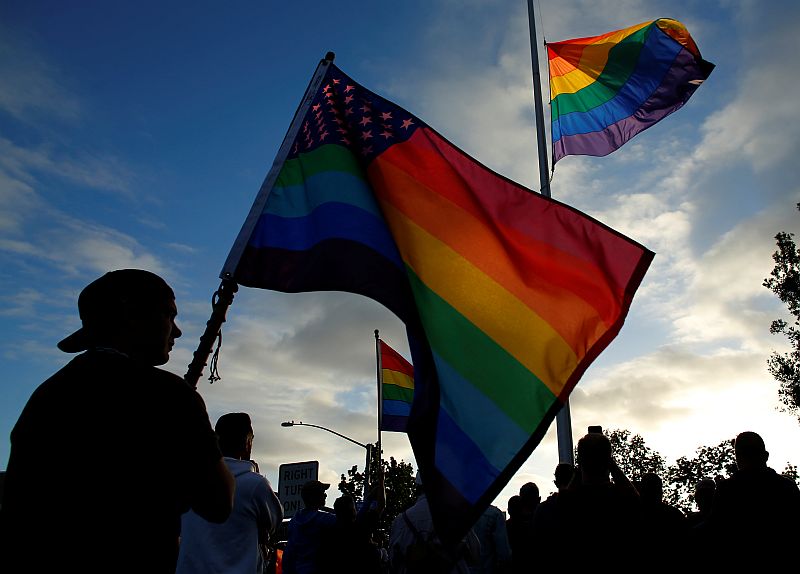 Mourners gather under an LGBT pride flag flying at half-mast for a candlelight vigil in remembrance for mass shooting victims in Orlando, from San Diego June 12, 2016. u00e2u20acu201d Reuters pic