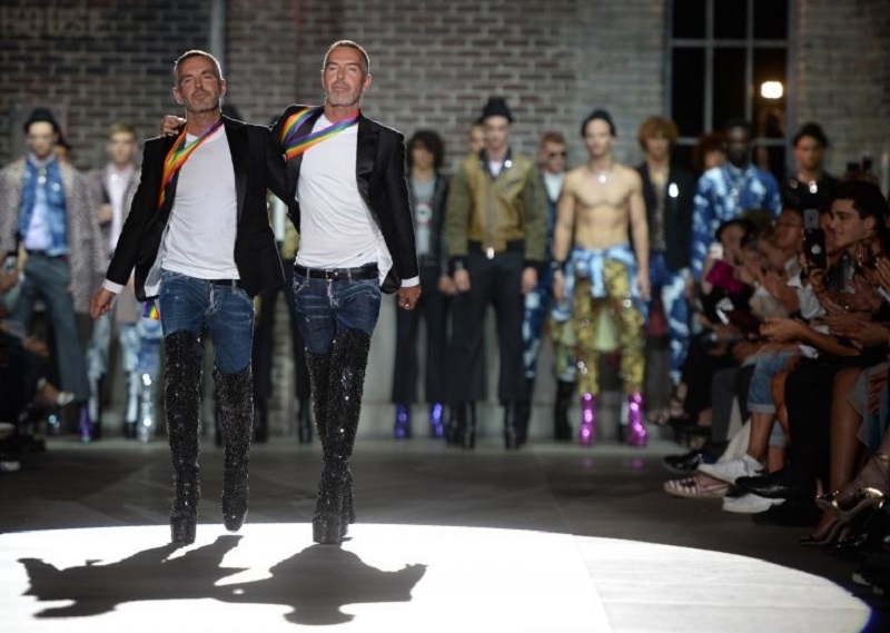 Fashion designers Dan Caten and Dean Caten greet the audience at the end of the show for fashion house Dsquared2. u00e2u20acu201d AFP pic