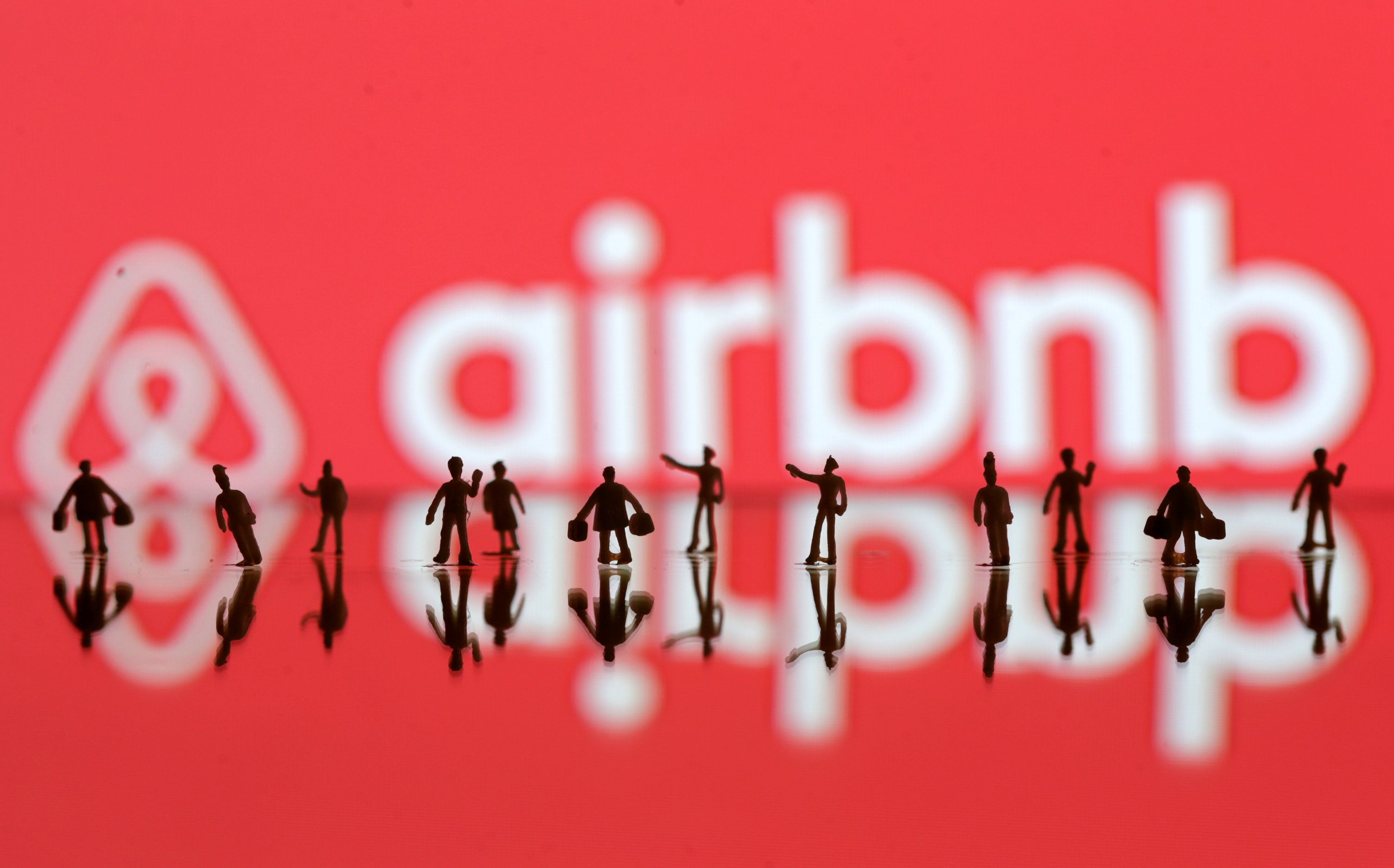 A 3D printed peopleu00e2u20acu2122s models seen in front of a displayed Airbnb logo in this illustration taken June 8, 2016. REUTERS/Dado Ruvic/Illustration