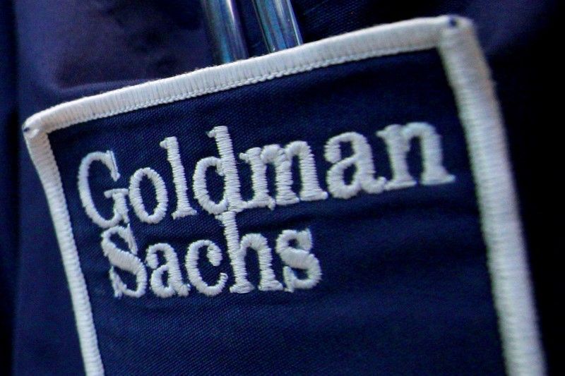 The logo of Dow Jones Industrial Average stock market index listed company Goldman Sachs seen on the clothing of a trader working at the Goldman Sachs stall on the floor of the New York Stock Exchange April 16, 2012. REUTERS/Brendan McDermid/File Photo