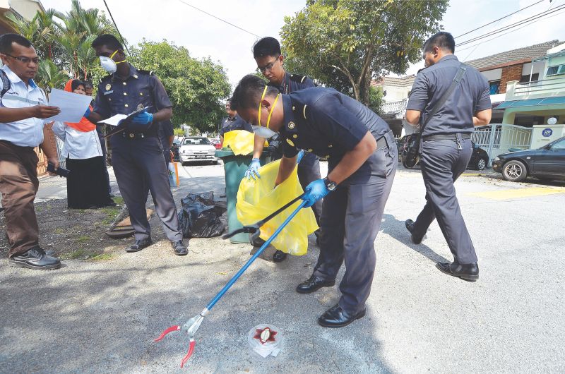 SWCorp enforcement officers checking on waste separation in Bangsar Baru yesterday. u00e2u20acu201d Picture by Mukhriz Hazim