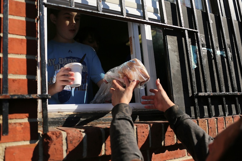 A youth volunteer with serves food to the needy and hungry at Cathedral Hall on October 11, 2012 in Camden, New Jersey.u00c2u00a0u00e2u20acu201d AFP pic