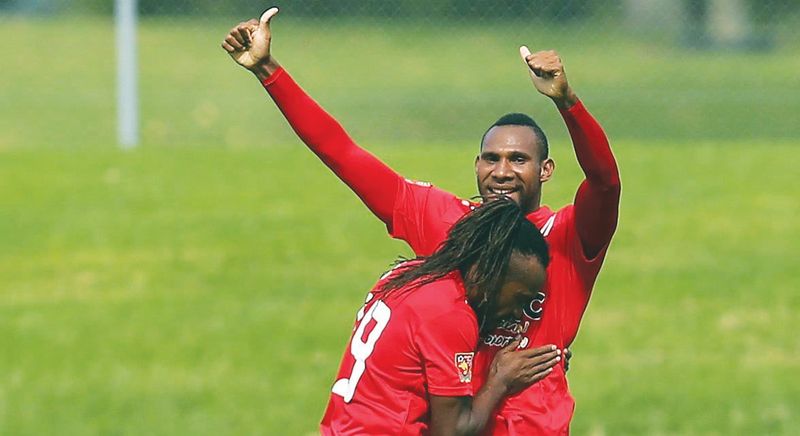 Semmy (right) scored both goals for Papua New Guinea. u00e2u20acu201d Malay Mail pic