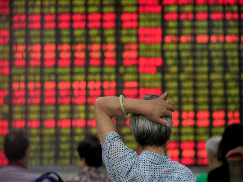 Investors look at an electronic board showing stock information at a brokerage house in Shanghai, China June 23, 2016. u00e2u20acu201d Picture by Reuters