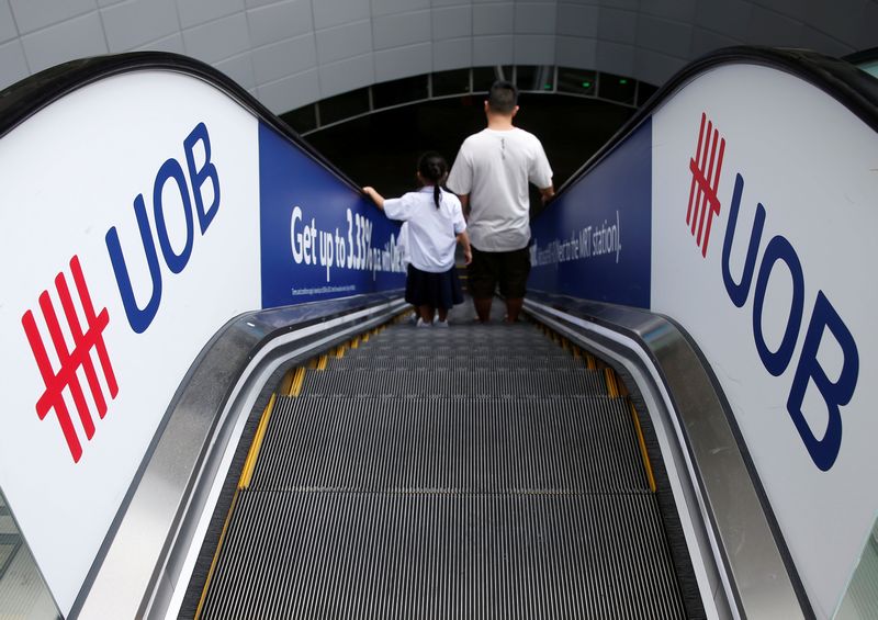 A man and his daughter passes United Overseas Bank (UOB) signage at a mall in Singapore May 11, 2016. u00e2u20acu201d Reuters pic