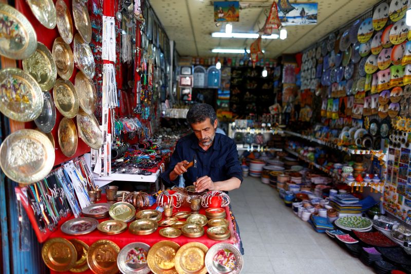 Kamel, 56, a brass carver and vendor of souvenirs, works at his shop as he waits for customers in the old city of Sousse, Tunisia June 23, 2016. — Reuters pic