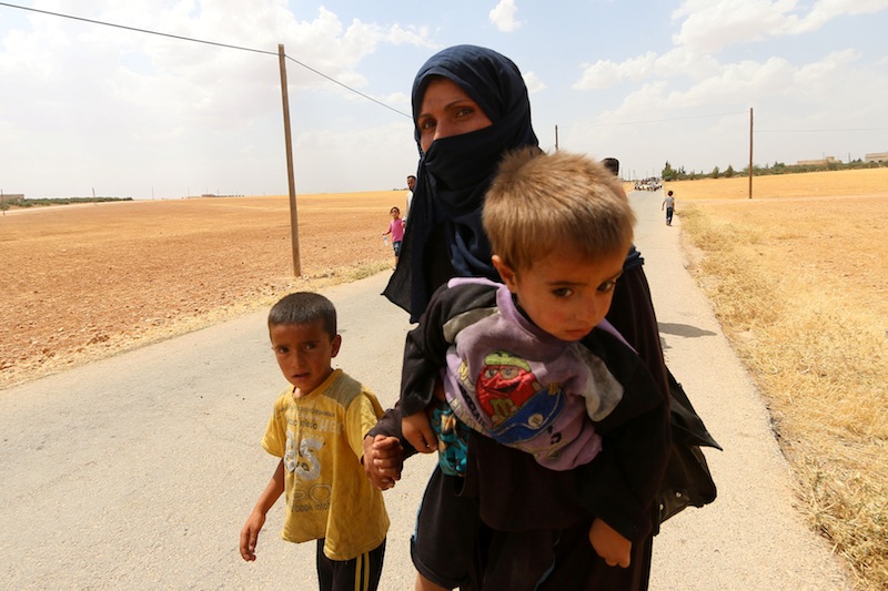 A woman, who fled the violence in Manbij city, arrives with her children to the southeastern rural area of Manbij, in Aleppo Governorate, Syria June 19, 2016. u00e2u20acu201d Reuters pic
