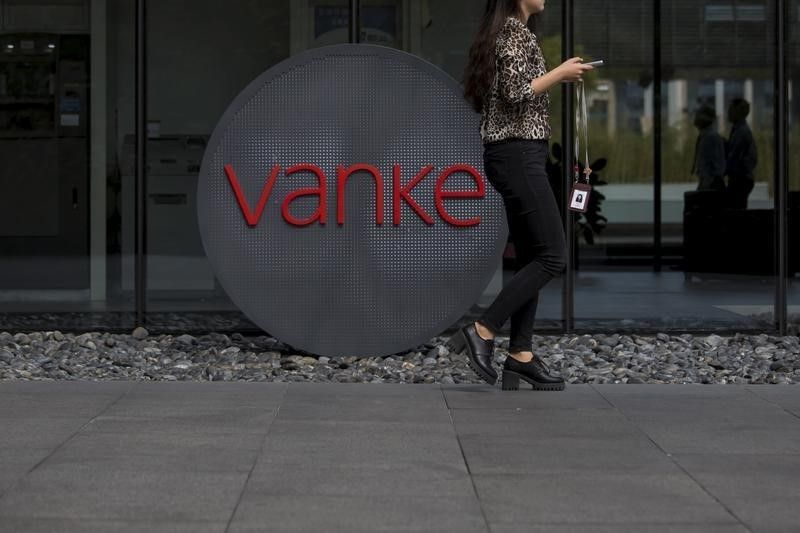 An employee walks past a logo of Vanke at its headquarters in Shenzhen, south China's Guangdong province November 2, 2015. u00e2u20acu201d Reuters pic