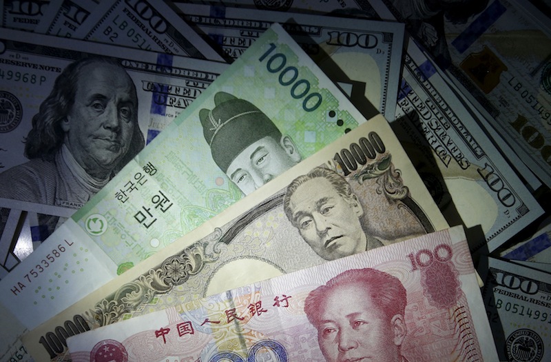 South Korean won, Chinese yuan and Japanese yen notes are seen on US 100 dollar notes in this picture illustration December 15, 2015. u00e2u20acu201d Reuters pic