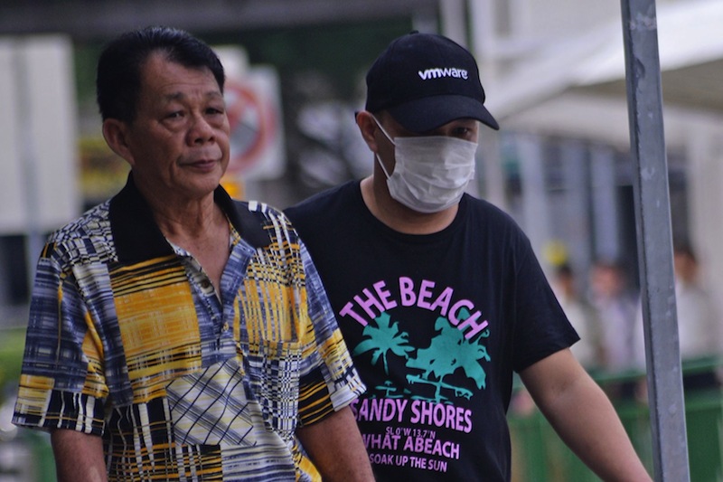 Lee Wai Leong (wearing face mask), who pleaded guilty to throwing a cat from a HDB block, arriving at the State Courts today. u00e2u20acu201d TODAY pic