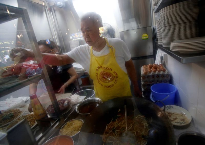 Hawker Chen Fu Yuan, 72, sells Char Kway Teow (fried noodles) in his stall at a hawker centre in Singapore, May 21, 2016. u00e2u20acu201d Reuters pic