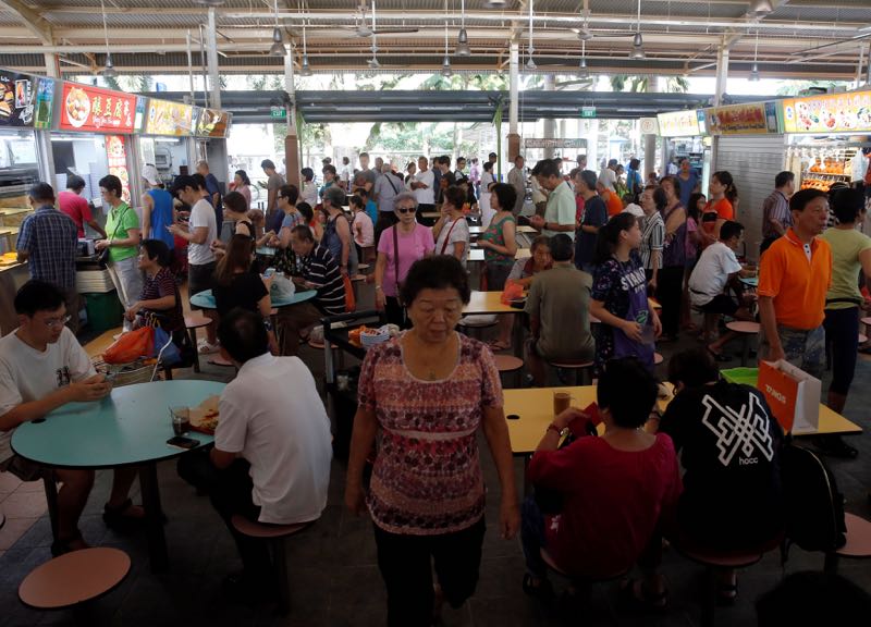 People queue for food at a hawker centre in Singapore May 21, 2016. — Reuters pic