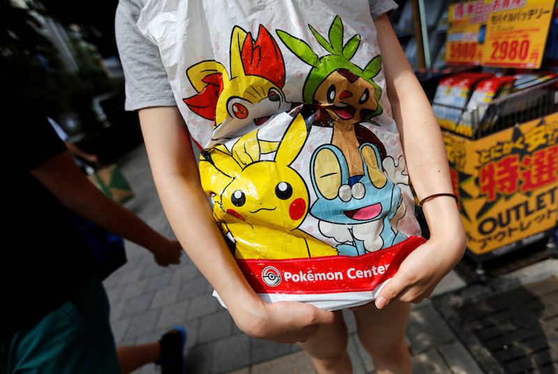 A woman holds a shopping bag of Pokemon in Tokyou00e2u20acu2122s Akihabara district July 20, 2016. u00e2u20acu201d Reuters pic