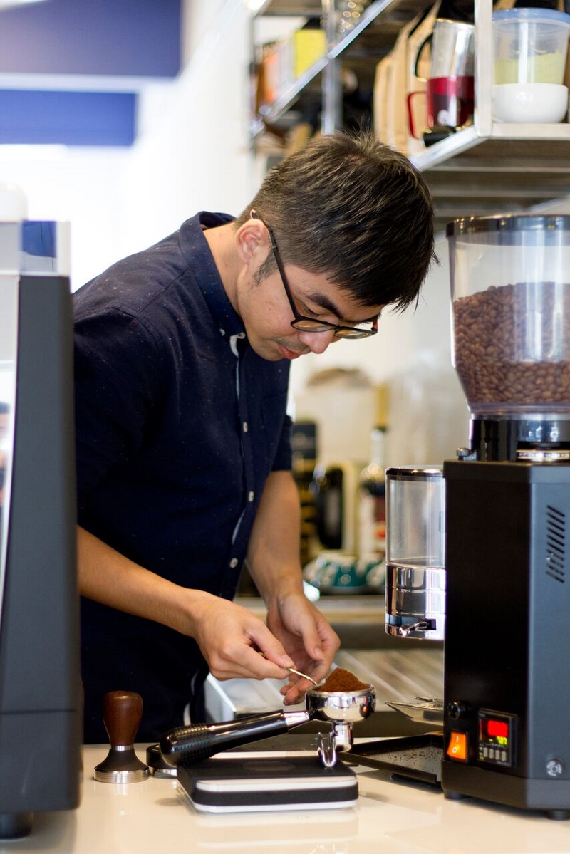 Alpha Brew Coffee’s head barista, Pee Weng Foo, tamping coffee grounds.