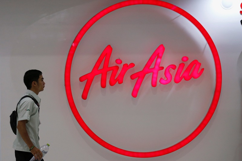 A man walks past the logo of AirAsia at Don Muang International Airport in Bangkok, Thailand, June 14, 2016. u00e2u20acu201d Reuters pic