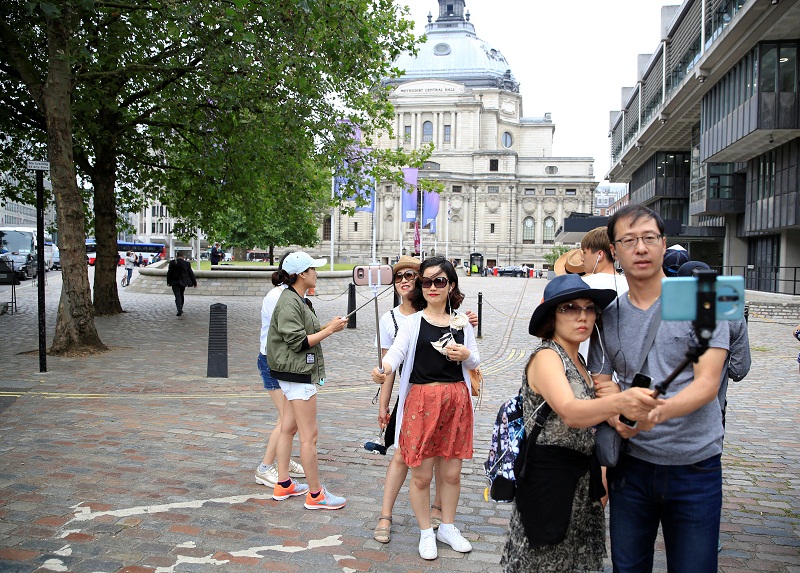 Tourists take selfies outside Methodist Central Hall in London July 22, 2016. u00e2u20acu201d Reuters pic
