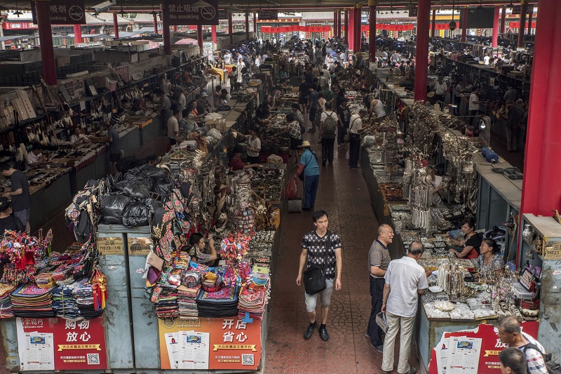 Covered alleys of stalls at the Panjiayuan Antique Market in Beijing, July 9, 2016. — Picture by Gilles Sabrie/The New York Times