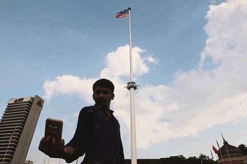 A man takes a selfie with the Jalur Gemilang in the background at Dataran Merdeka yesterday. u00e2u20acu201d Picture by Hari Anggara