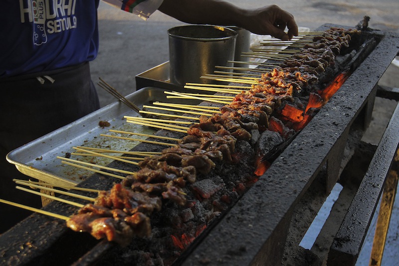 Something about skewered meat grilled over an open coal fire... yummy. u00e2u20acu201d Pictures by Yusof Mat Isa