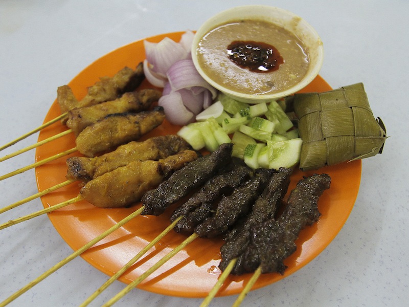 Satay is always served with a peanut sauce with a dollop of sambal, chunks of raw cucumber and onions and of course ketupat.