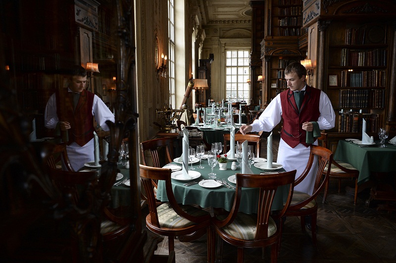 A waiter adjusts tables at the Cafe Pushkin, in the home of an 18th-century Russian nobleman, in Moscow, July 15, 2016. u00e2u20acu201d Picture by James Hill/The New York Times