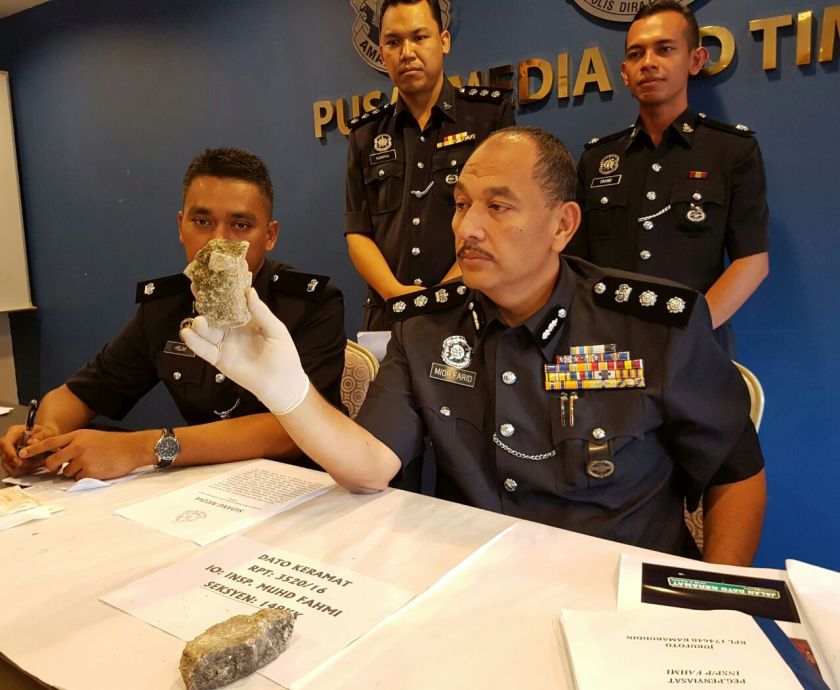 Northeast district police chief ACP Mior Faridalatrash Wahid showing the stones used in the commotion last night. u00e2u20acu2022 Picture by Opalyn Mok