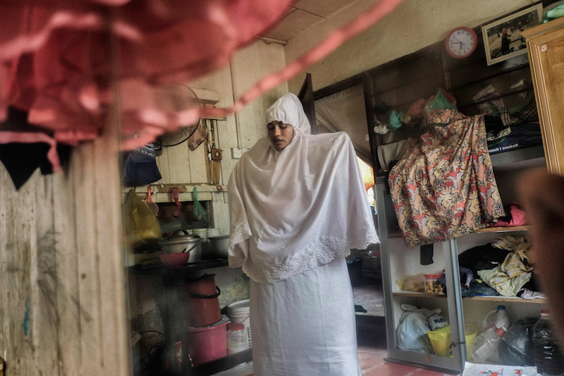 Hasinah Izhar, one of many refugees from among Myanmar’s persecuted Rohingya minority, prays in her family’s rented room in George Town June 15, 2016. — Picture by Rahman Roslan/The New York Times