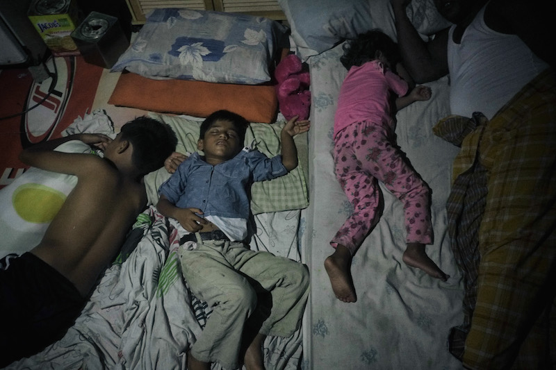 Dil Muhammad Rahman, a Rohingya refugee, and his three children rest in the rented room the family shares in George Town June 15, 2016. — Picture by Rahman Roslan/The New York Times