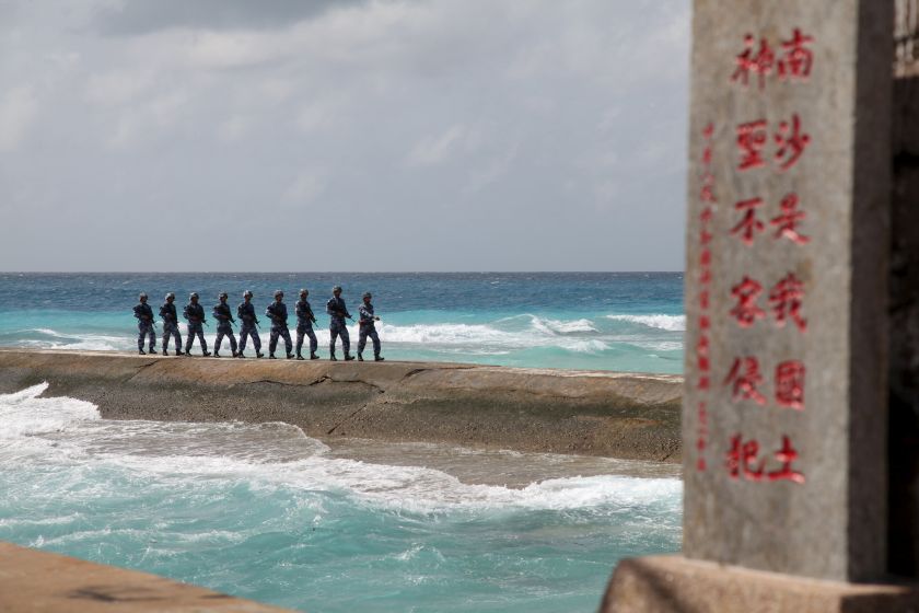 File photo of soldiers of Chinau00e2u20acu2122s Peopleu00e2u20acu2122s Liberation Army (PLA) Navy patrolling near a sign in the Spratly Islands, known in China as the Nansha Islands, February 9, 2016. u00e2u20acu201d Afp-Relaxnews pic