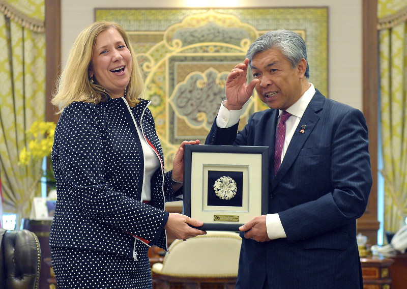 Deputy Prime Minister Datuk Seri Dr Ahmad Zahid Hamidi presenting a gift to Susan Coppedge, US Ambassador-at-Large, after receiving her in his office at Bangunan Perdana Putra in Putrajaya, July 26, 2016. u00e2u20acu201d Bernama pic