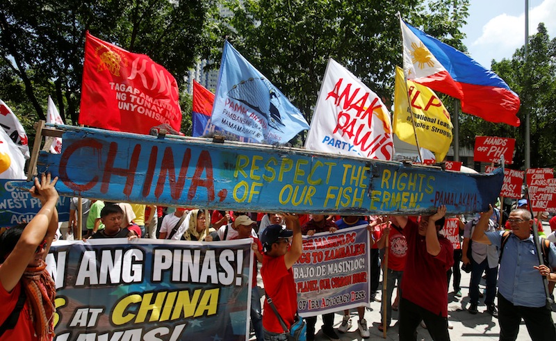 Demonstrators display a part of a fishing boat with anti-China protest signs outside the Chinese Consulate in Makati City, Metro Manila, Philippines July 12, 2016. u00e2u20acu201d Reuters pic
