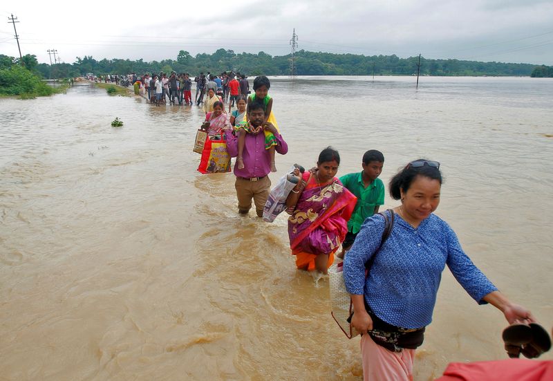 People wade through a flooded road after heavy rains on the outskirts of Agartala, India July 18, 2016. u00e2u20acu201d Reuters pic