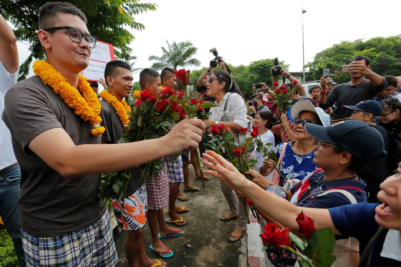 Six anti-constitutional referendum activists receive red roses from their supporters after a Thai military court ordered their release on bail in Bangkok July 6, 2016. u00e2u20acu201d Reuters pic