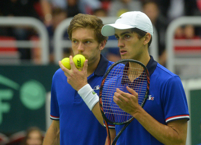 Pierre-Hugues Herbert of France (right) and his compatriot Nicolas Mahut react as they play against Radek Stepanek and Lukas Rosol of Czech Republic in a double tennis match at the Davis Cup quarter-final match Czech Republic vs France on July 16, 2016 in
