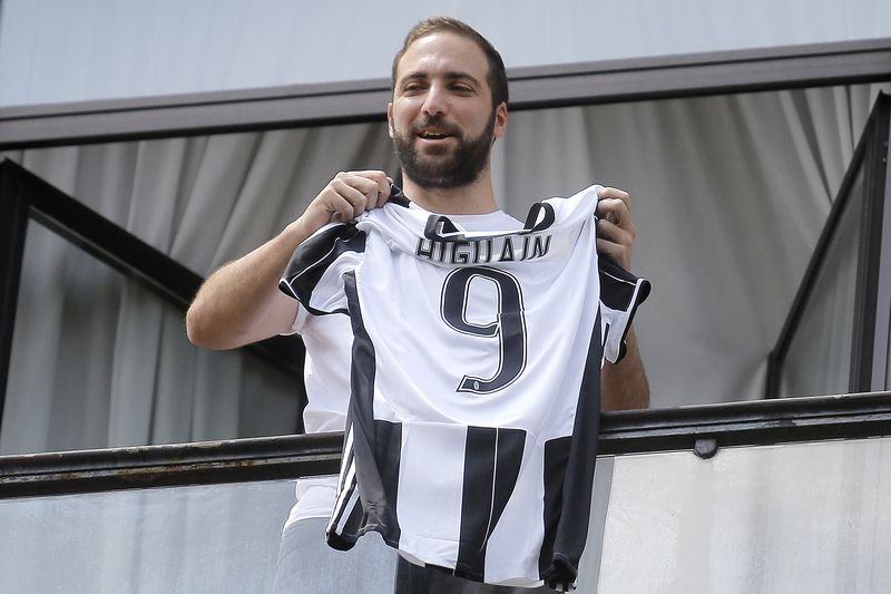 Juventus' forward Gonzalo Higuain from Argentina holds his jersey at the Juventus' headquarter in Turin on July 27, 2016. u00e2u20acu201d AFP pic