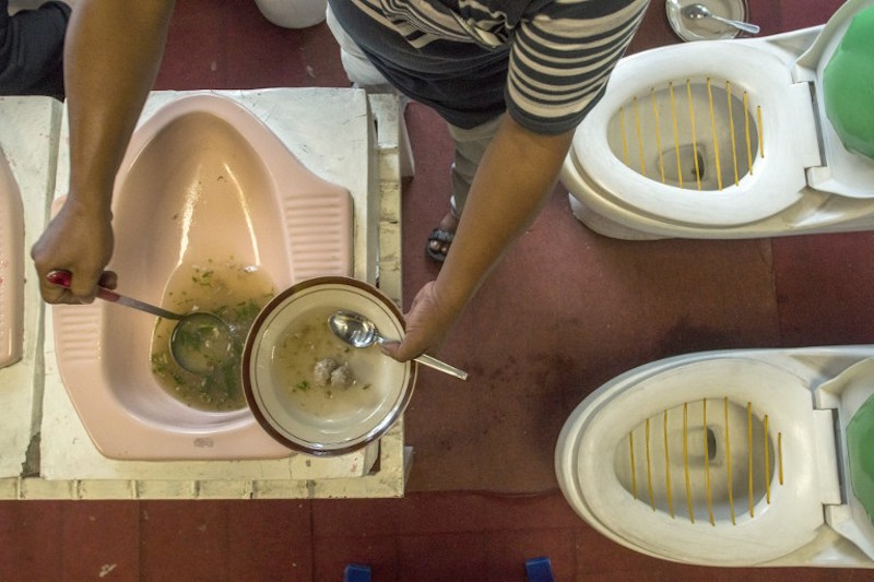 Customers are served meatball soup from a squat toilet during a meal at the u00e2u20acu02dcJamban Cafeu00e2u20acu2122 in the city of Semarang July 16, 2016. u00e2u20acu201d AFP pic