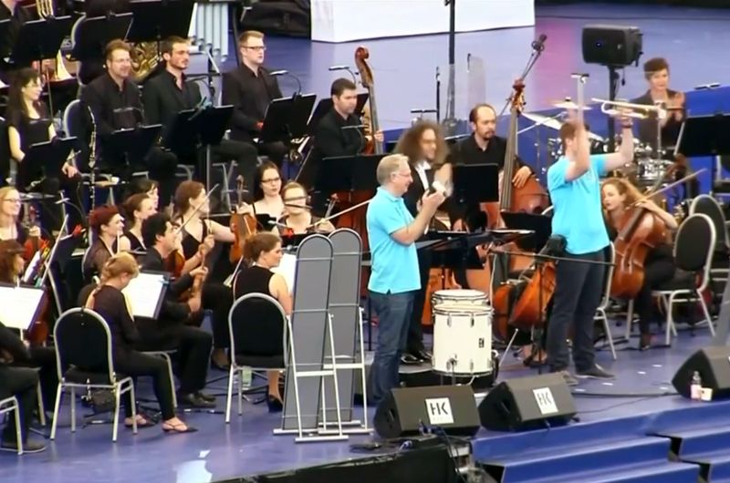 Image of the world's largest orchestra performing at the Frankfurt stadium from the Reuters video.