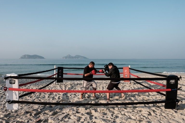 Rio Boxing trainer Moacyr Lima (L) trains Leandro Guignoni in beach boxing at Pepe beach in Rio de Janeiro July 26, 2016. u00c2u00a9 YASUYOSHI CHIBA / AFP