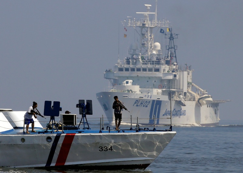 Members of the Phillippine coastguard pose as pirates while Japan Coast Guard sails past during the Joint Maritime Law Enforcement Exercise off Manila Bay, Philippines, July 13, 2016. u00e2u20acu201d Reuters pic
