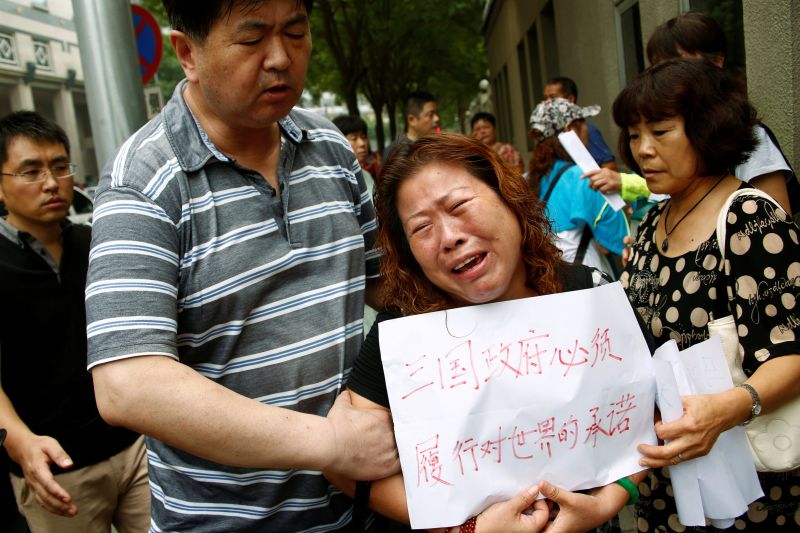 A family member of a passenger aboard Malaysia Airlines flight MH370 which went missing in 2014 reacts during a protest outside the Chinese foreign ministry in Beijing, July 29, 2016. u00e2u20acu2022 Reuters pic