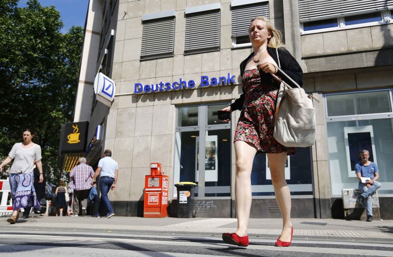 A woman walks in front of a branch of Germanyu00e2u20acu2122s Deutsche Bank in Cologne, Germany, July 18, 2016. REUTERS/Wolfgang Rattay
