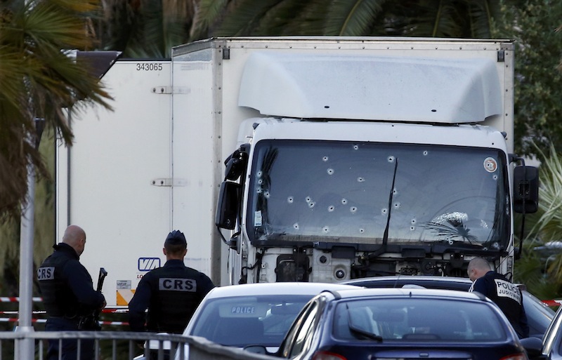 French CRS and judicial police work near the heavy truck that ran into a crowd at high speed celebrating the Bastille Day July 14 national holiday on the Promenade des Anglais killing 80 people in Nice, France, July 15, 2016. u00e2u20acu201d Reuters pic