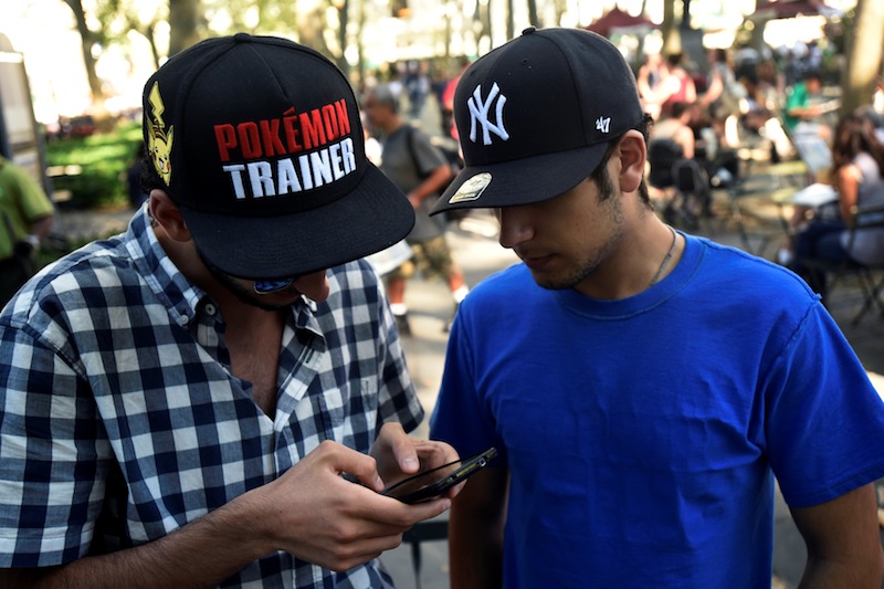 A man wears a Pokemon-themed hat as he plays the augmented reality mobile game 'Pokemon Go' by Nintendo in New York July 11, 2016. u00e2u20acu201d Reuters pic