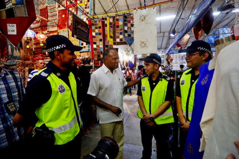 Minister K Shanmugam speaking to some national servicemen patrolling and managing crowd at the Geylang Serai Bazaar on July 4, 2016. u00e2u20acu201d TODAY pic
